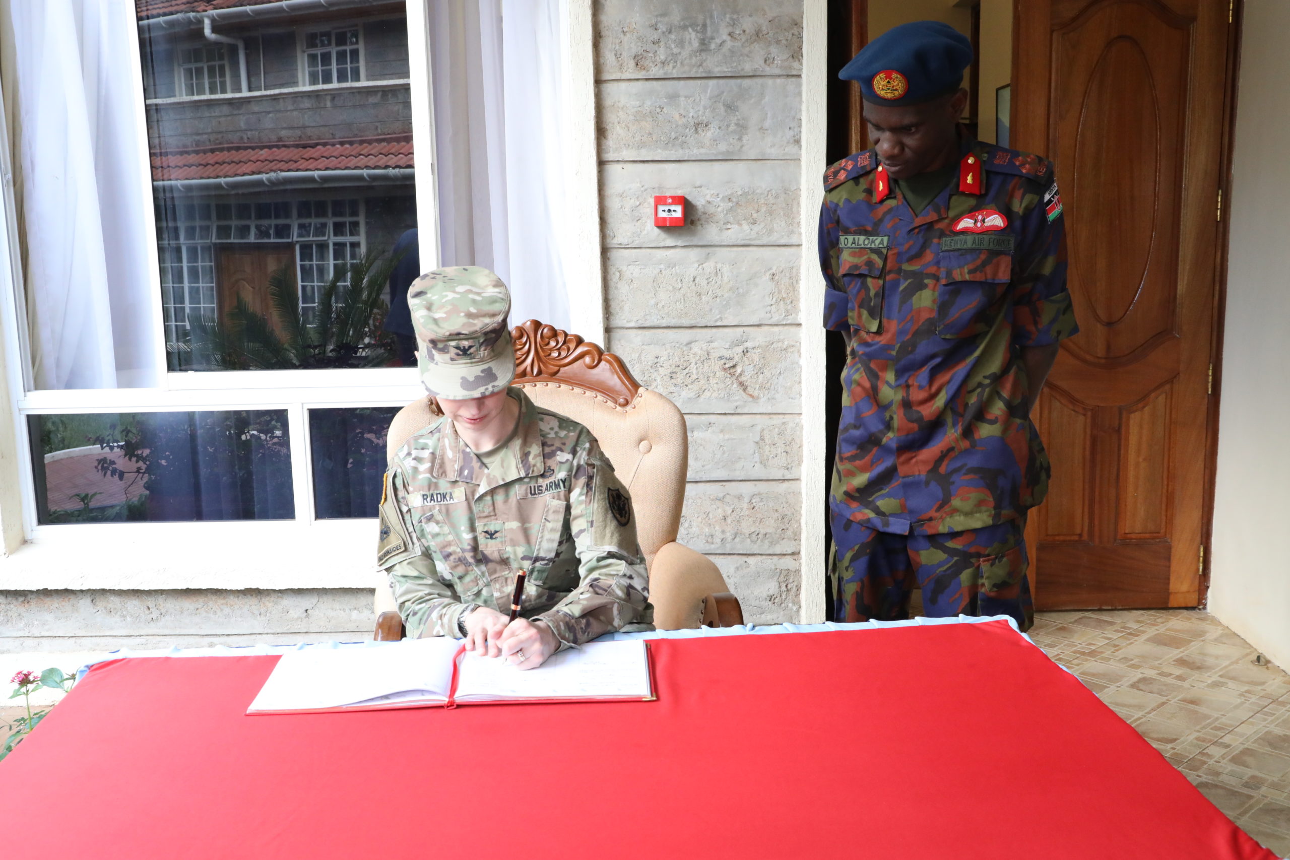 Head of Delegation Col Karen Radka US Department of National War College signs visitors book at NDC on 27 March 2023.