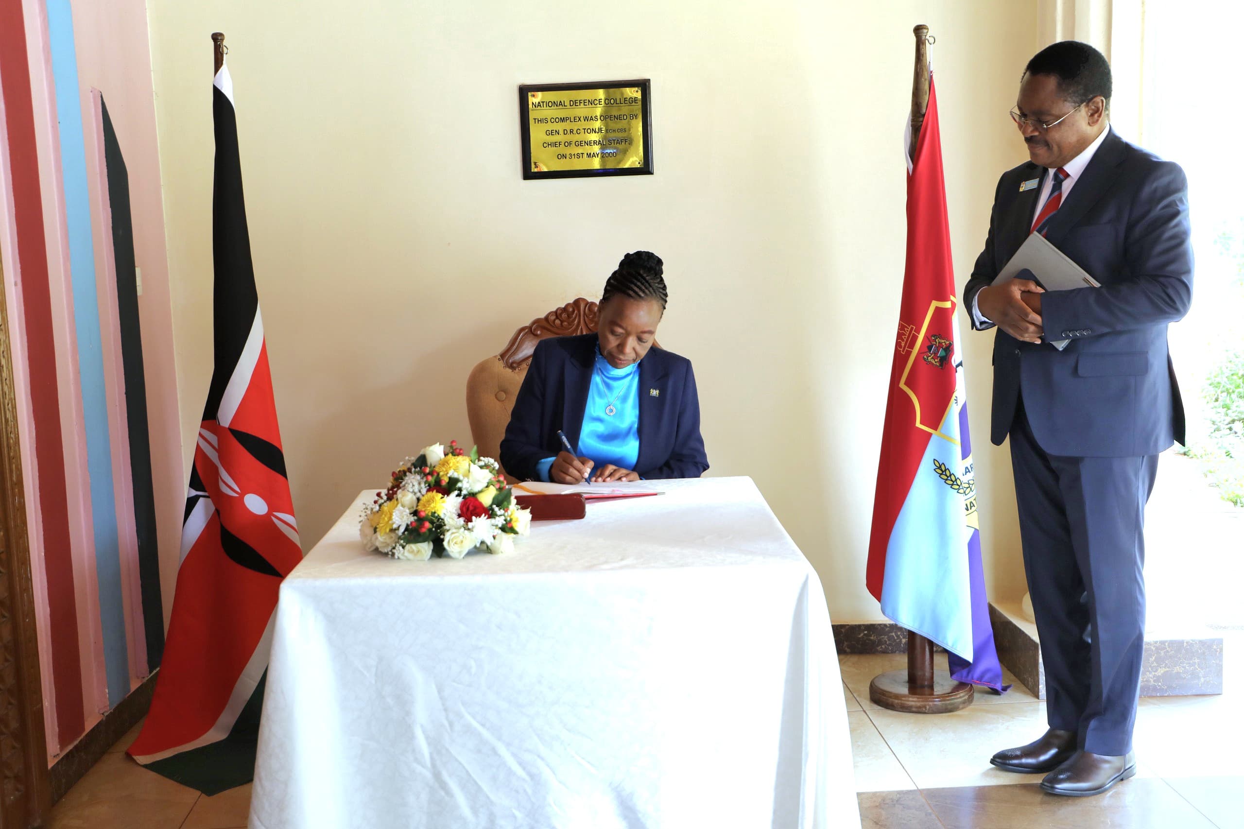 Amb Juma visitors book signing